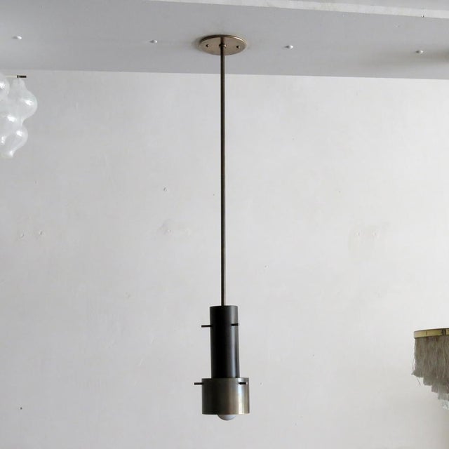 Wonderful Italian articulate pendant light in patinaed brass and enameled aluminum, wired for US standards or European...