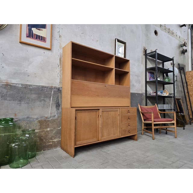 This incredible cabinet & secretaire was designed by world-famous Danish designer Hans Wegner during the 1960's. This...