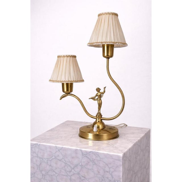 A striking and sculptural swedish art deco table lamp attributed to ystad-metall, dating to the 1930s. This elegant piece...