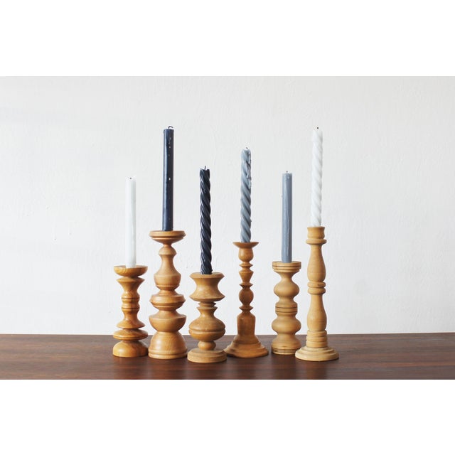 A decorative set of six vintage wooden candleholders, designed in the style of mid-20th-century Scandinavian design. All...