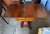 Empire-style sewing or work table featuring two drawers, hinged drop leaves, and a shaped pedestal supported by a platform...