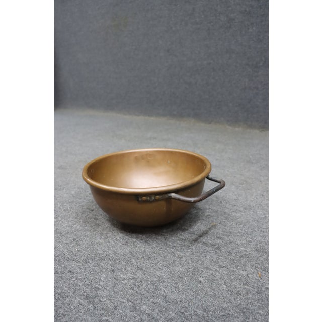 Antique solid copper mixing bowl with a classic rounded form and riveted iron side handles. Originally intended for food...