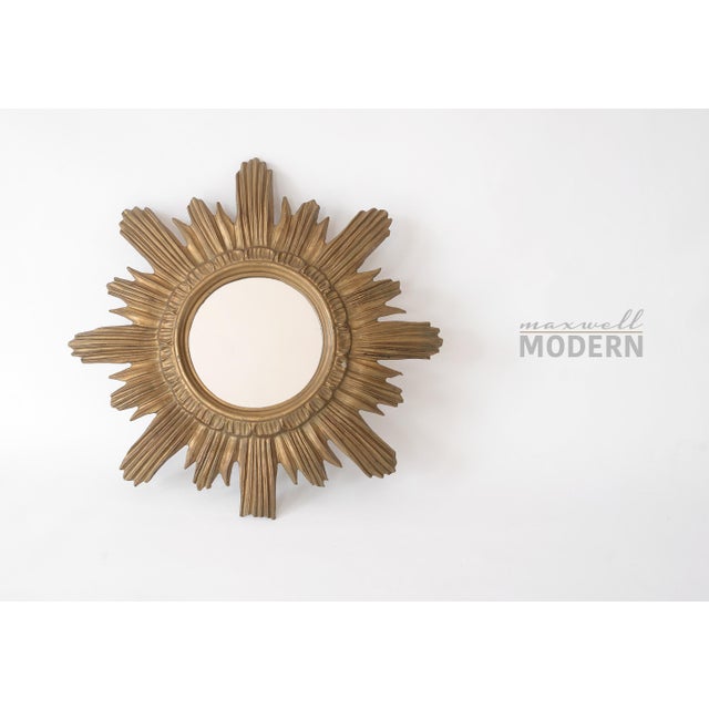 Beautiful small Italian starburst mirror made of resin mimicking hand-carved wood with 8 long rays and 8 short rays....