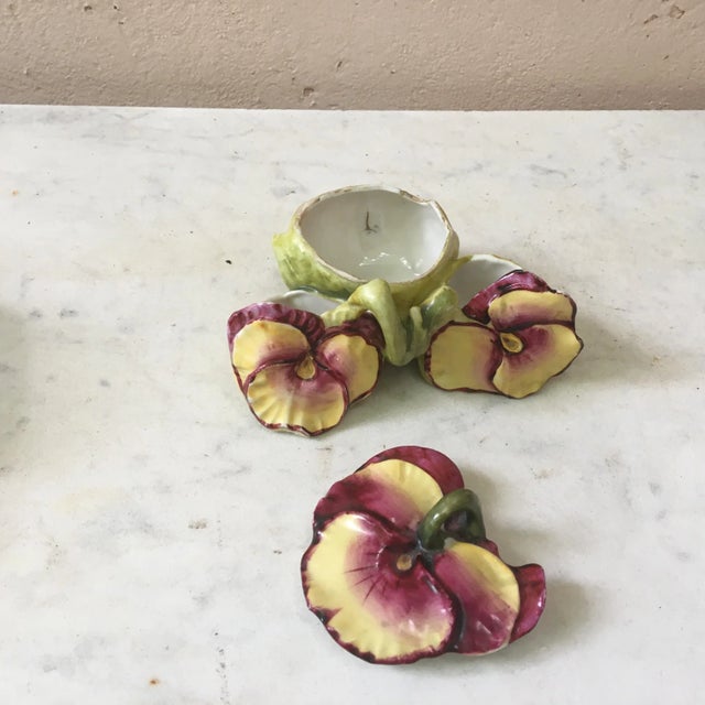 Porcelain salt cellar in the form of three purple-and-yellow pansies, circa 1900.