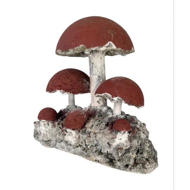 This striking mid-century style garden sculpture features a cluster of six stylized mushrooms emerging from a craggy,...