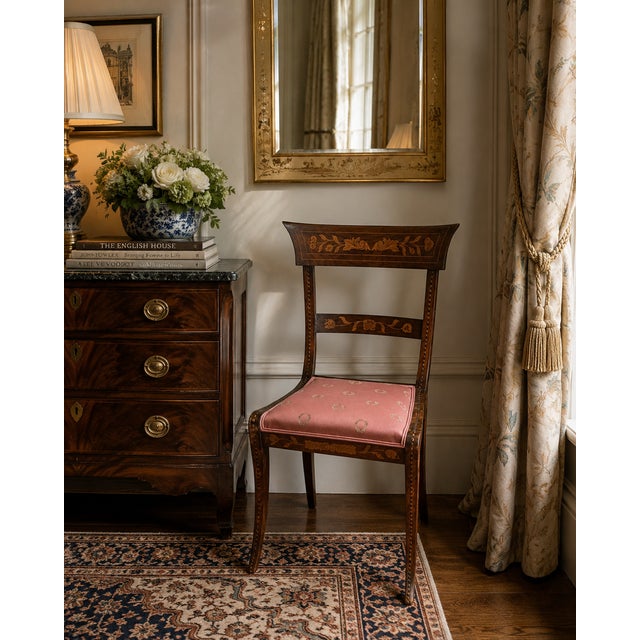 This striking armless side chair is a fine example of late 19th century Dutch craftsmanship, featuring an elegant Regency-...