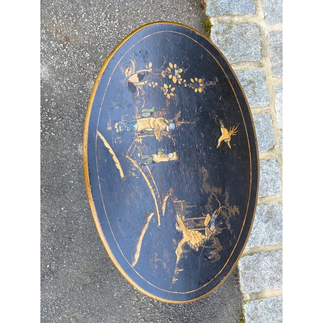 Vintage chinoiserie table. Black painted background with painted accents. Wood construction with some chipping to surface...