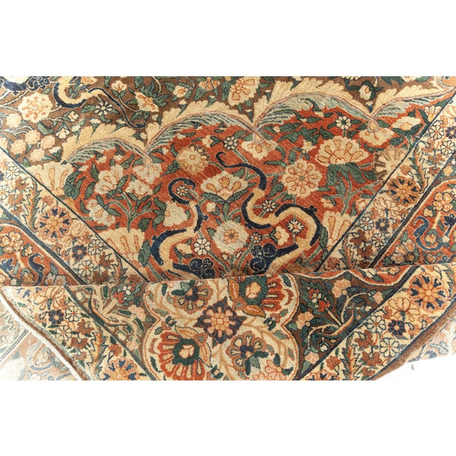 This stunning circa-1920 antique Persian Kirman carpet features an ornate all-over design that captures the eye with its...