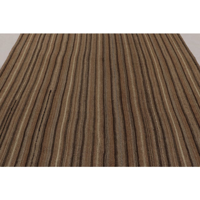 Made with handwoven wool in Persia 1950-1960, this 7x10 vintage Bidjar Kilim is a particularly earthy and sought-after...