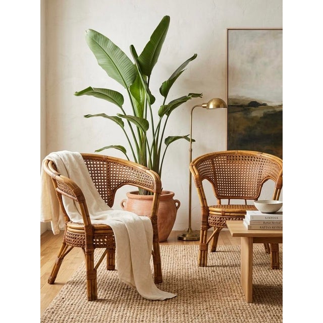 Bring an effortless touch of organic modern texture to your space with this stunning pair of vintage mid-century rattan...