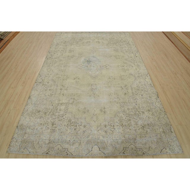 An authentic vintage traditional Tabriz rug hand-knotted with fine wool and natural dyes. This oriental rug features a...