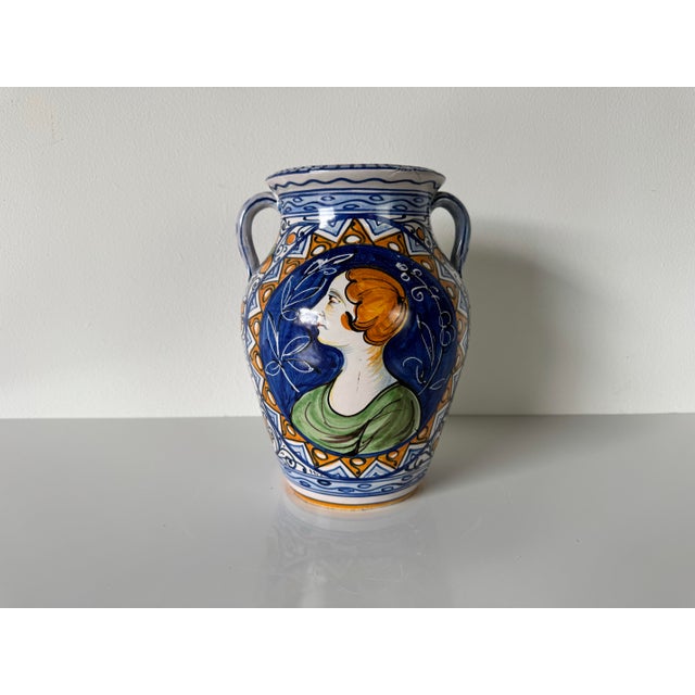 This charming vintage Italian hand-painted ceramic vase showcases a classic Mediterranean aesthetic, blending vibrant...
