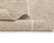 Lines that cross, turn, and wander: a desert map drawn in ivory on warm sand. Fine ivory lines crisscross a heathered sand...
