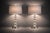 A stately pair of late 20th century Hollywood Regency revival table lamps featuring stacked faceted crystal-style spheres...