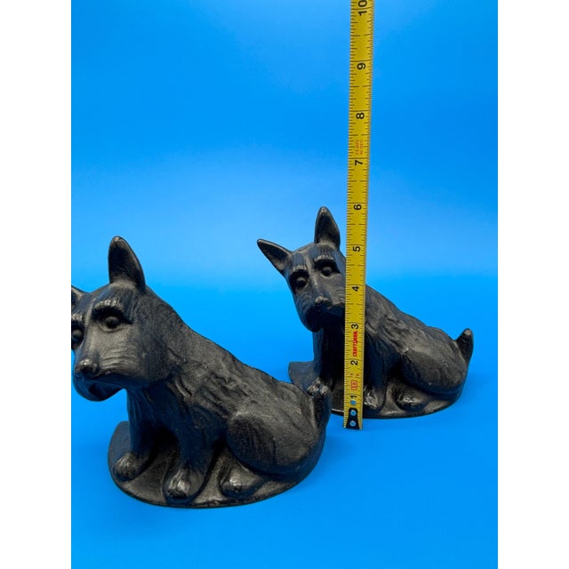 Charming pair of black cast iron Scottie dog bookends. These feature a classic Scottish Terrier design with nice...