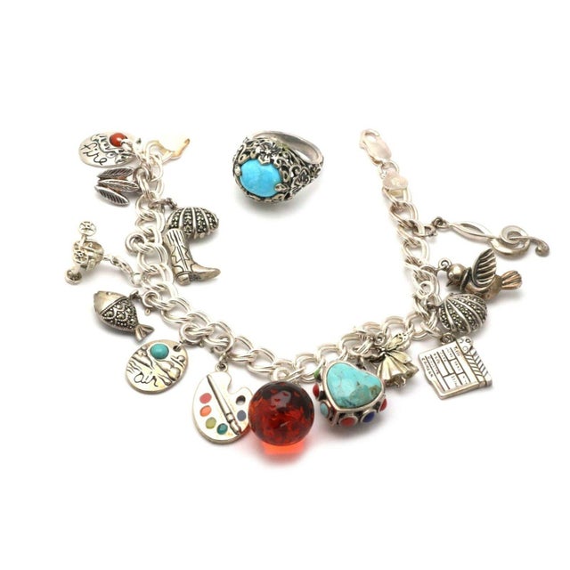 This is an eye catching LOT OF 2 pieces of jewelry, a multi charms bracelet and ring. Both crafted from sterling silver...