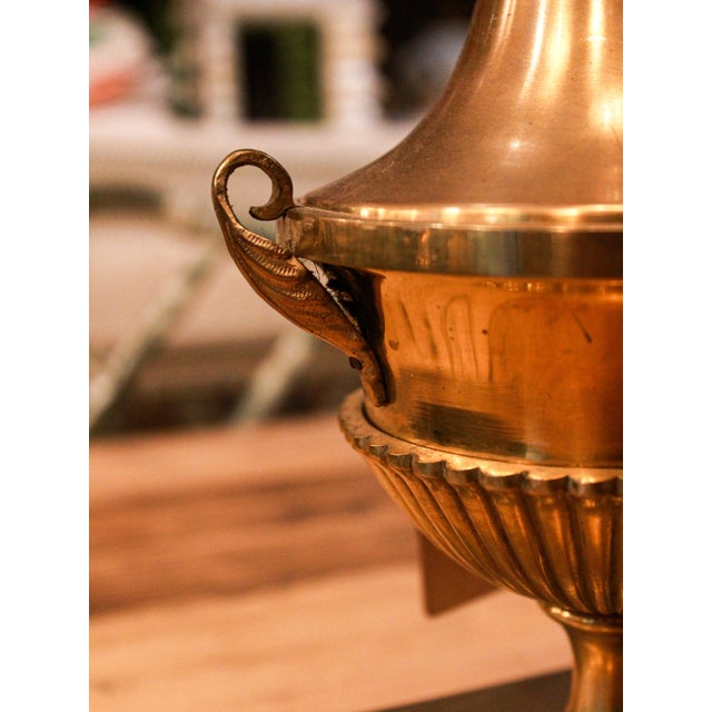 Brass lamps with square bases and leaf-shaped handles, typical of classic mid-century design. Original pieces from the...