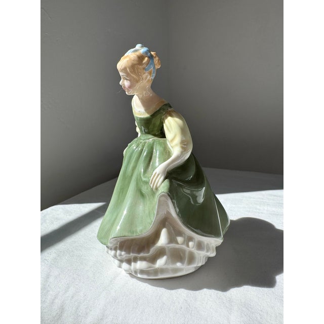 The Royal Doulton Figurine "Fair Maiden" HN 2211 is an English bone china figure produced by Royal Doulton, issued in the...