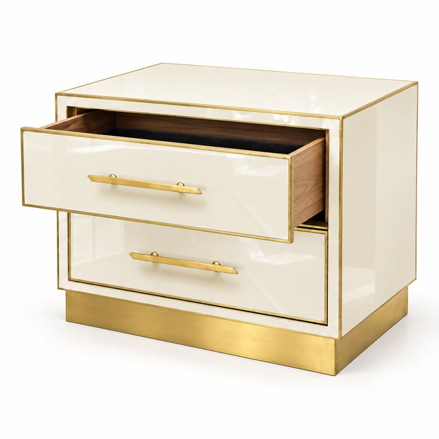 A matching pair of contemporary Italian bedside cabinets in ivory Murano glass, each with two drawers framed in polished...