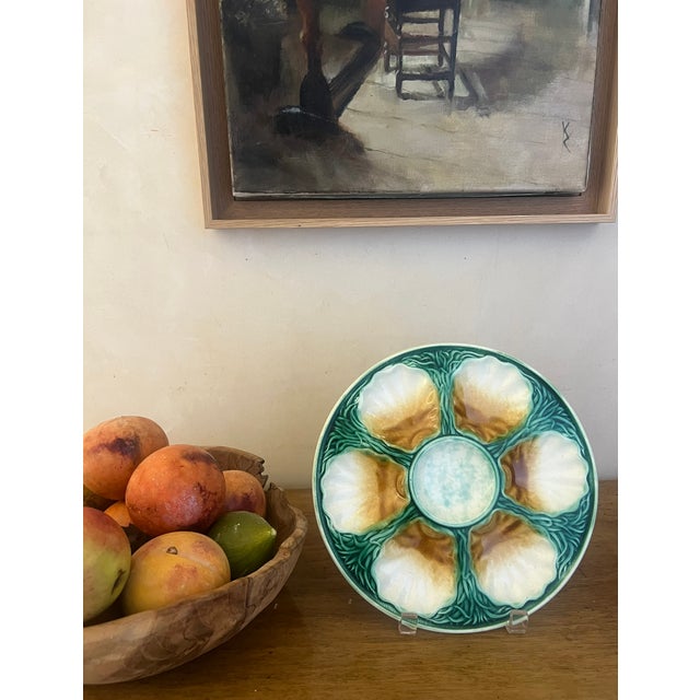 French majolica oyster plate with six wells surrounded by seaweed. A sauce well for lemon wedges is at the center. Stamped...