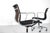 Set of four swivel chairs, model "ea 117", in black fabric, brown fabric backrest, and chrome frame on casters, height...