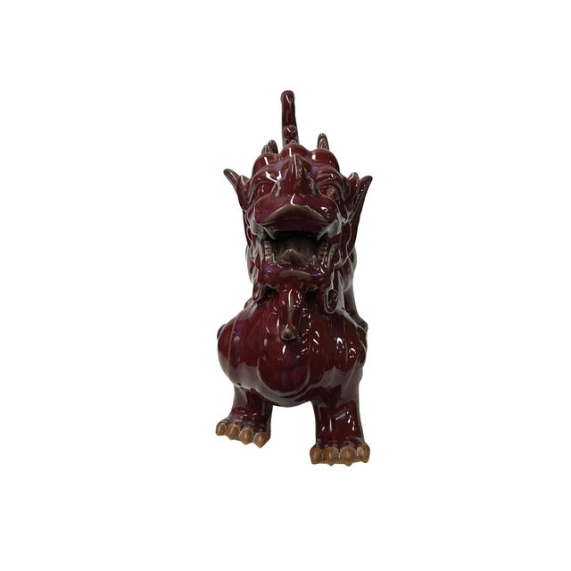 This striking ceramic sculpture depicts a Pixiu (or Bixie), a mythical Chinese protector creature, rendered in a deep,...