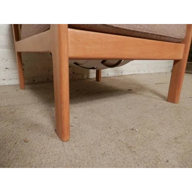 Comfortable lounge chair with ottoman in a sculpted maple frame. Thick cushions and head rest and tufted ottoman....