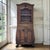 A Country French Regence violin vitrine in richly patinated walnut, its swelling bombé sides tracing the graceful...