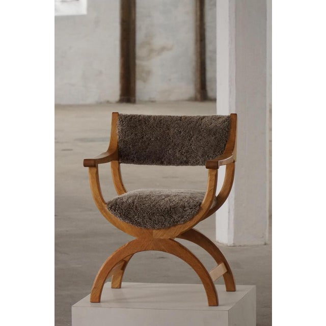 A fine and elegant armchair in solid oak, designed by henning kjærnulf for eg kvalitetsmøbel, denmark, 1960s. Model...