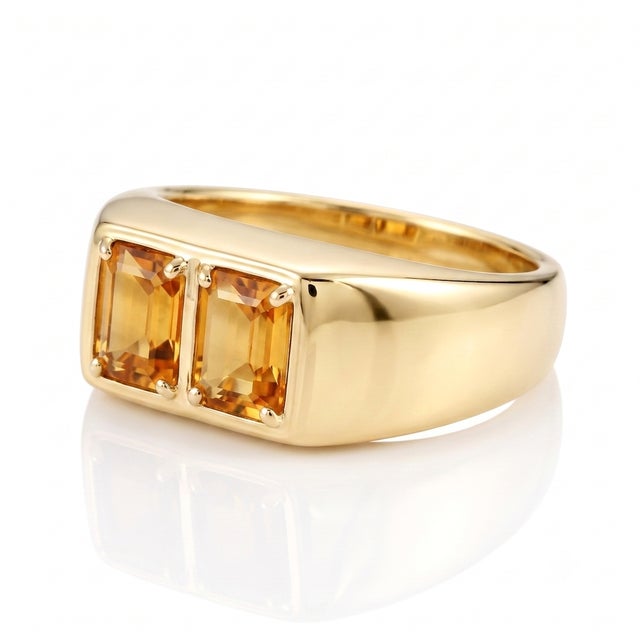 Infuse your style with golden luminosity through this chunky, polished band designed to highlight twin step-cut gemstones...