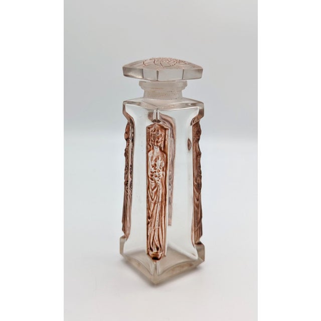 This exceptional clear glass perfume bottle, titled "Ambre D'Orsay", was designed by René Lalique for the renowned French...