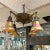 Metal American Arts and Crafts Style Iridescent Glass and Bronze 4 Light Chandelier For Sale - Image 7 of 12