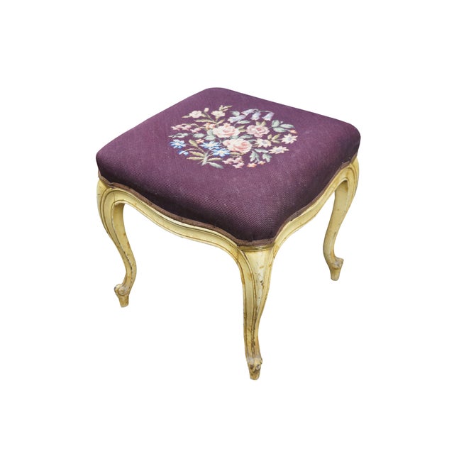 Early to mid 20th century vanity bench / stool. Off white painted cabriole legs; grape purple needlepoint seat embroidered...