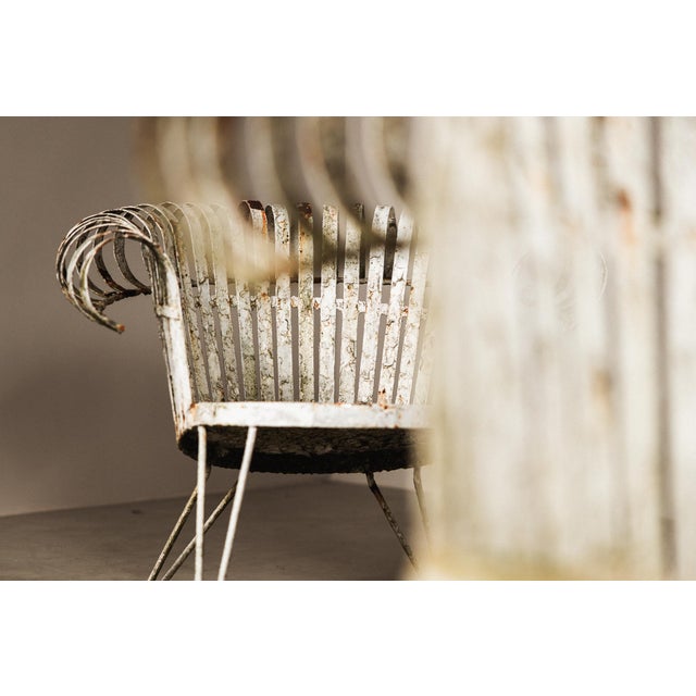 A highly distinctive set of four sculptural wrought iron garden lounge chairs, most likely French and dating to the...