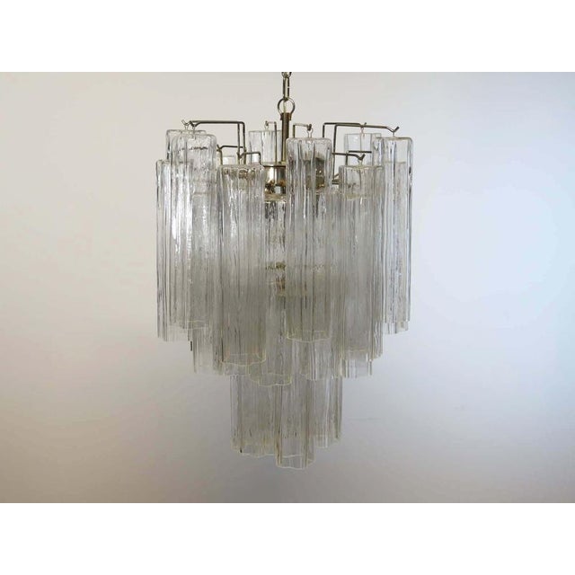 Pair of Italian vintage chandelier in Murano glass and nickel-plated metal structure. The armor polished nickel supports...