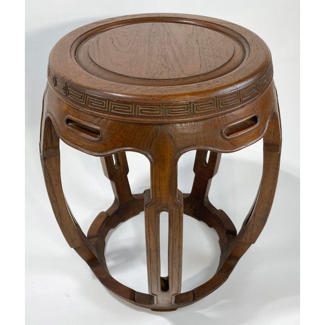 Vintage Asian wood garden stool circa 1960s. Features carved Greek Key pattern around top edge of seat with five carved...