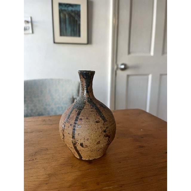 Beautiful little handmade pottery bud vase. Natural earth stoneware with black brown glaze drip detail in a mid century...
