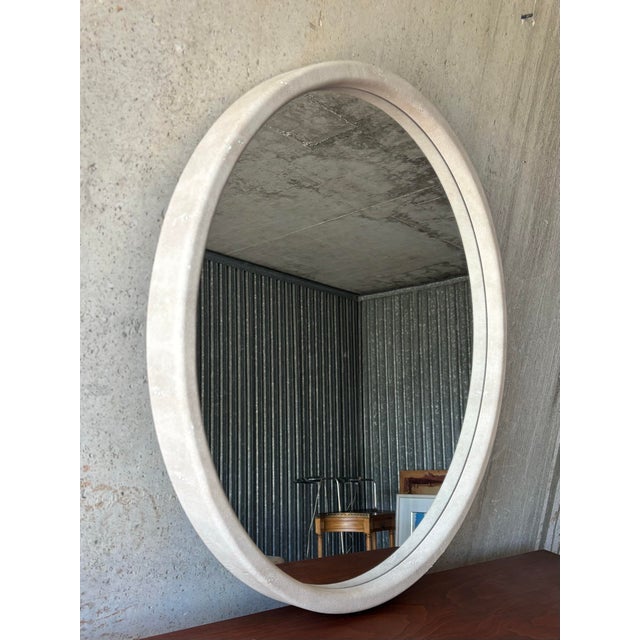 A stylish circular wall mirror finished in faux shagreen. The textured surface and refined organic finish are reminiscent...