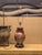 Ceramic cinnabar-colored with blue and white dragon details. Possibly originally a vase that was made into a lamp. Top and...