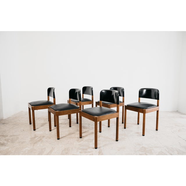 Dining set consisting of 6 wooden chairs with leather seat and black plastic back. Piarotto Production - Italy, 1960s...