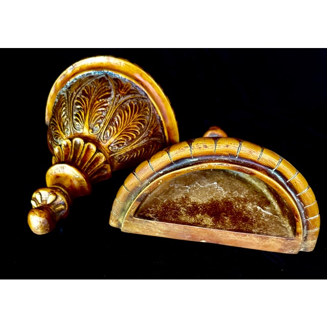 These decorative wall-mounted urns feature a classic Italian design finished in a gold leaf gilt style. Their semicircular...
