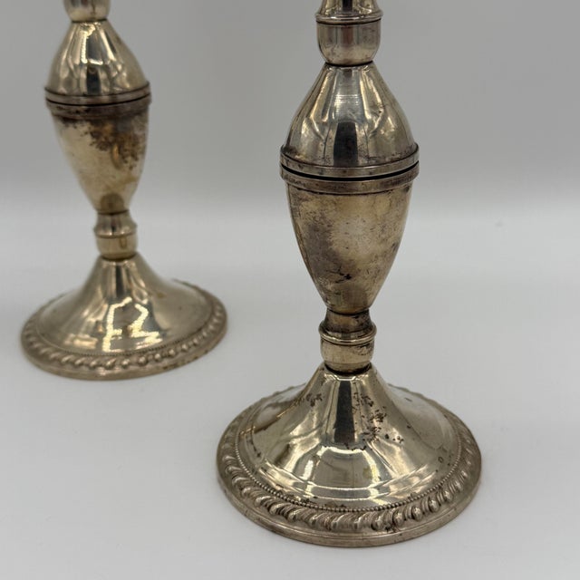 Classic, elegant, and beautifully proportioned, this pair of sterling silver three-arm candelabra were made by Duchin...