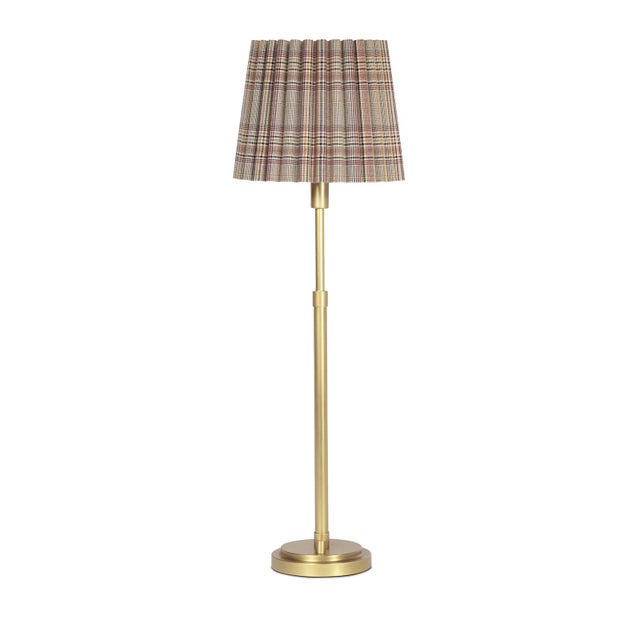 The Polly Buffet Table Lamp showcases sophistication with its single scalloped shade, casting a warm and inviting glow...