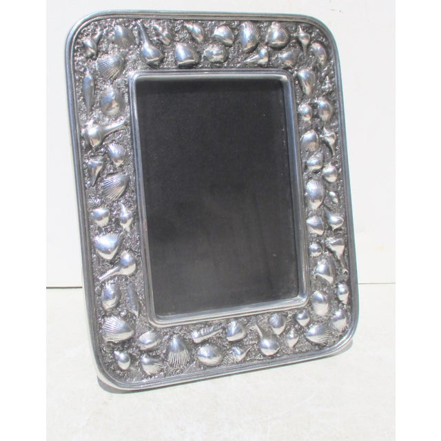 Shell border frame by Wilton Pewter. The window measures 7" by 5" and the frame measures 10" by 8". Clever design of...