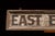 1920s Vintage “East Building” Painted Wood Directional Sign For Sale - Image 5 of 11