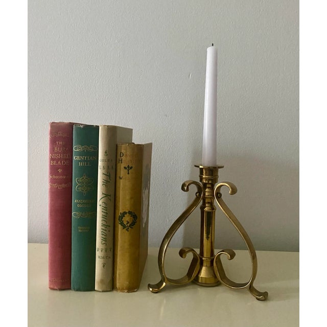 Art nouveau style candleholder. Made from solid brass. It has a three scroll leg design for a single candle taper. A...