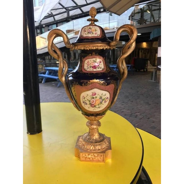 A pair of 20th century sevres style porcelain ormolu vases – dark, cobalt blue with rococo style motifs, scrolls, and...