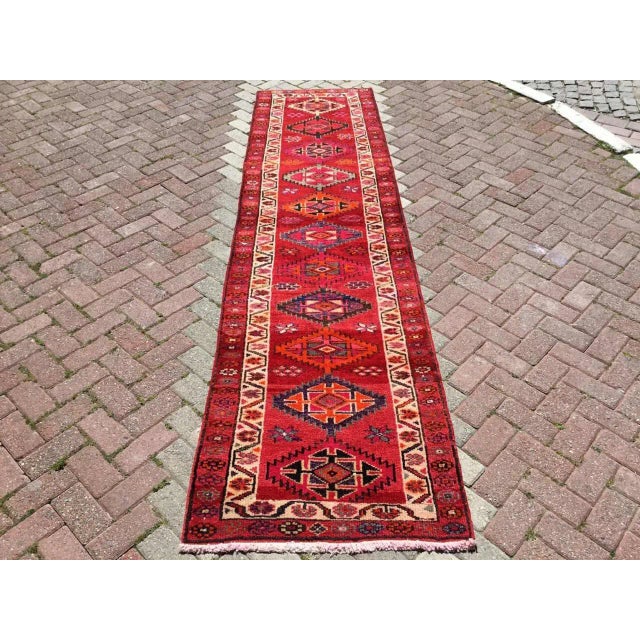 This gorgeous hand knotted vintage anatolian runner rug is approximately 70 years old in excellent vintage condition. The...