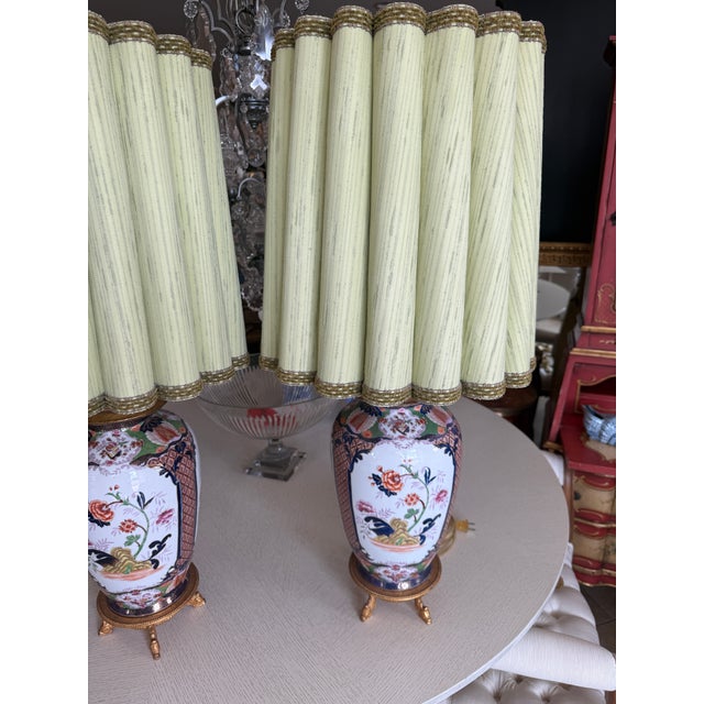 Beautiful and Elegant pair of Imari lamps with original fluted lampshade and gilded bases.