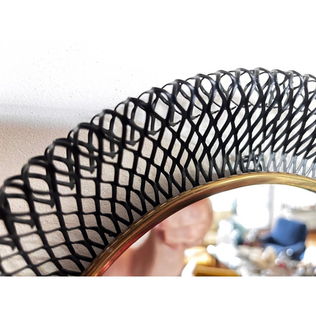 Black lacquered expanded metal mirror with a brass ribbon highlighter, in perfect condition I have official proof of...